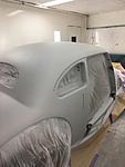 three additional coats of primer, each one rubbed back