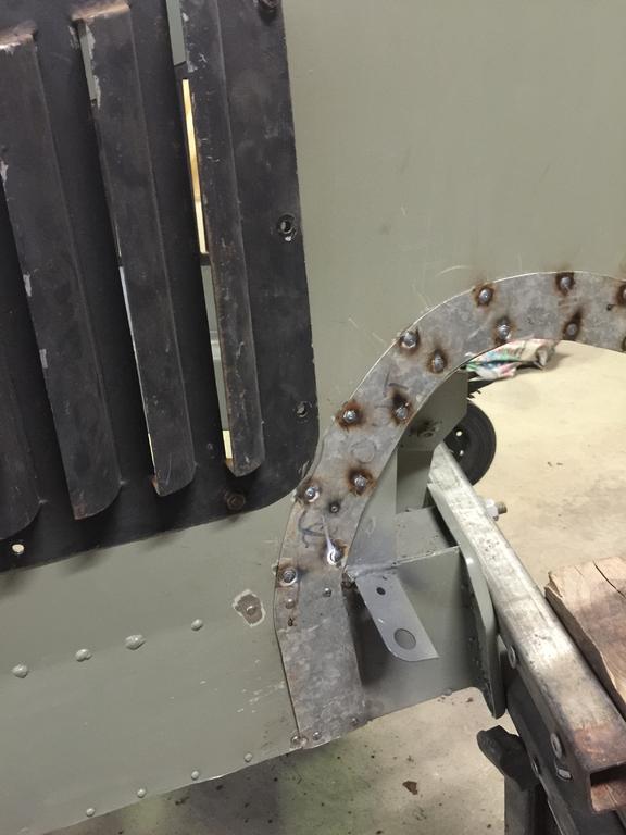 The inside front body panels on the early cars are very lightly built. Here we have made strengthening panels welded and riveted into place. We have the riveting technique perfected now and hundreds of new rivets will be put in.